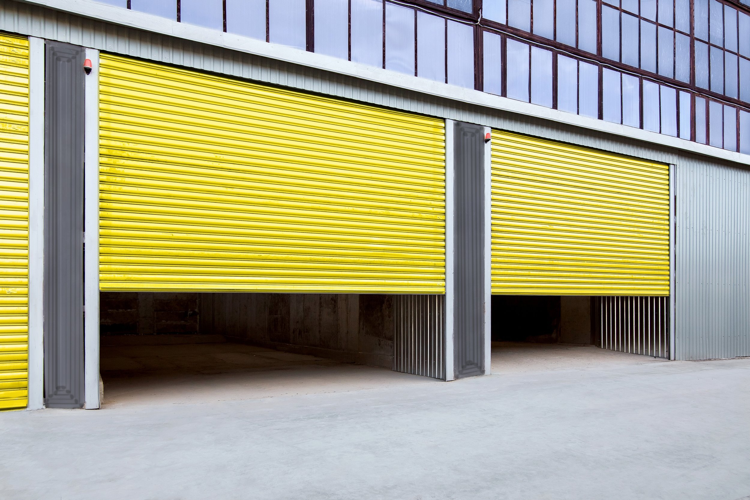 Opening,Yellow,Iron,Shutter,Door,Of,Garage,And,Industrial,Building