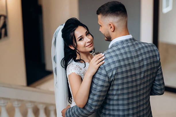 the first meeting of the bride and groom the first meeting of the bride and groom on the steps cages wedding dress stock pictures, royalty-free photos & images